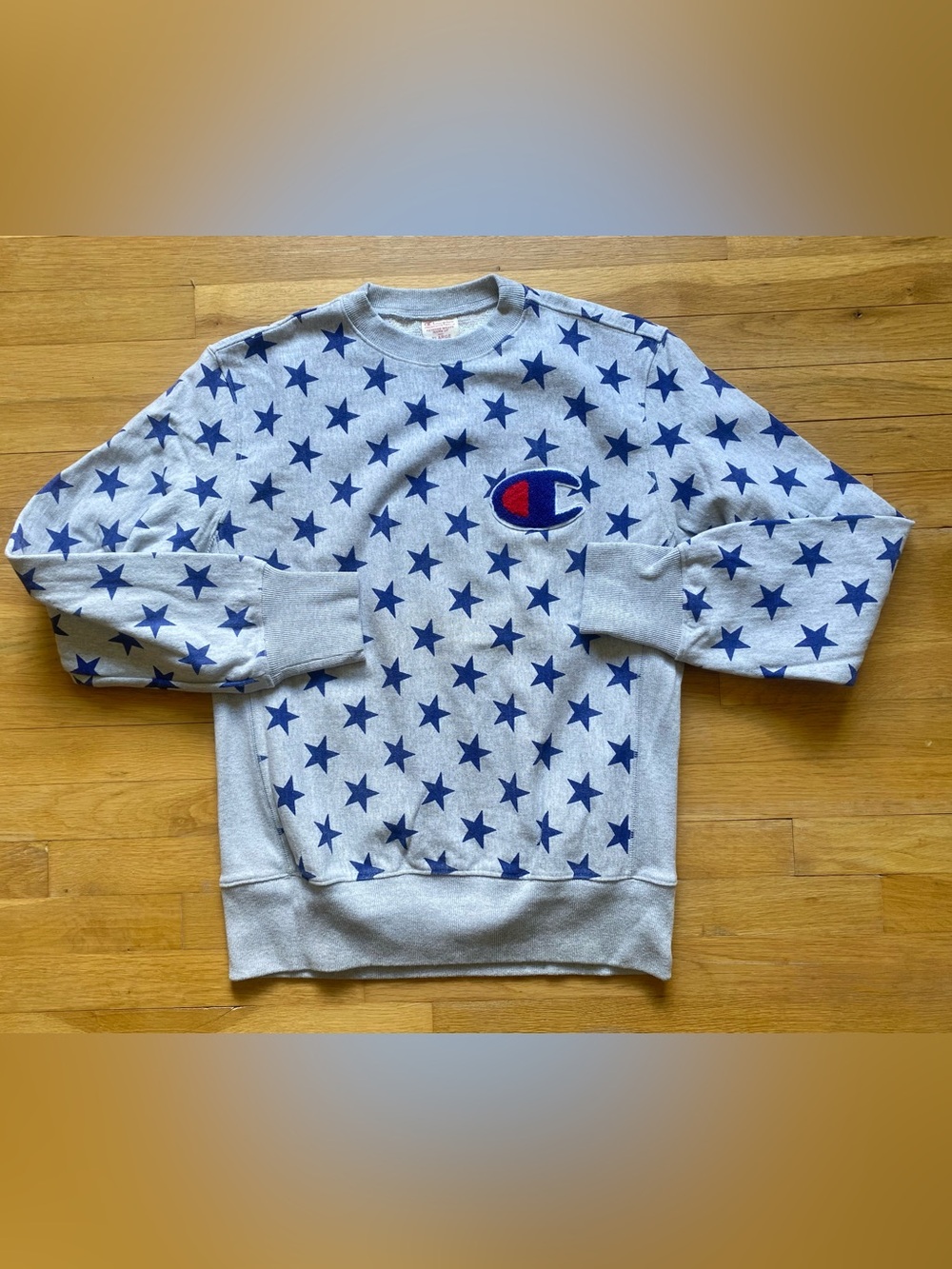 Champion Light Gray Crewneck Sweatshirt with Navy Star Print and Red Logo Accent